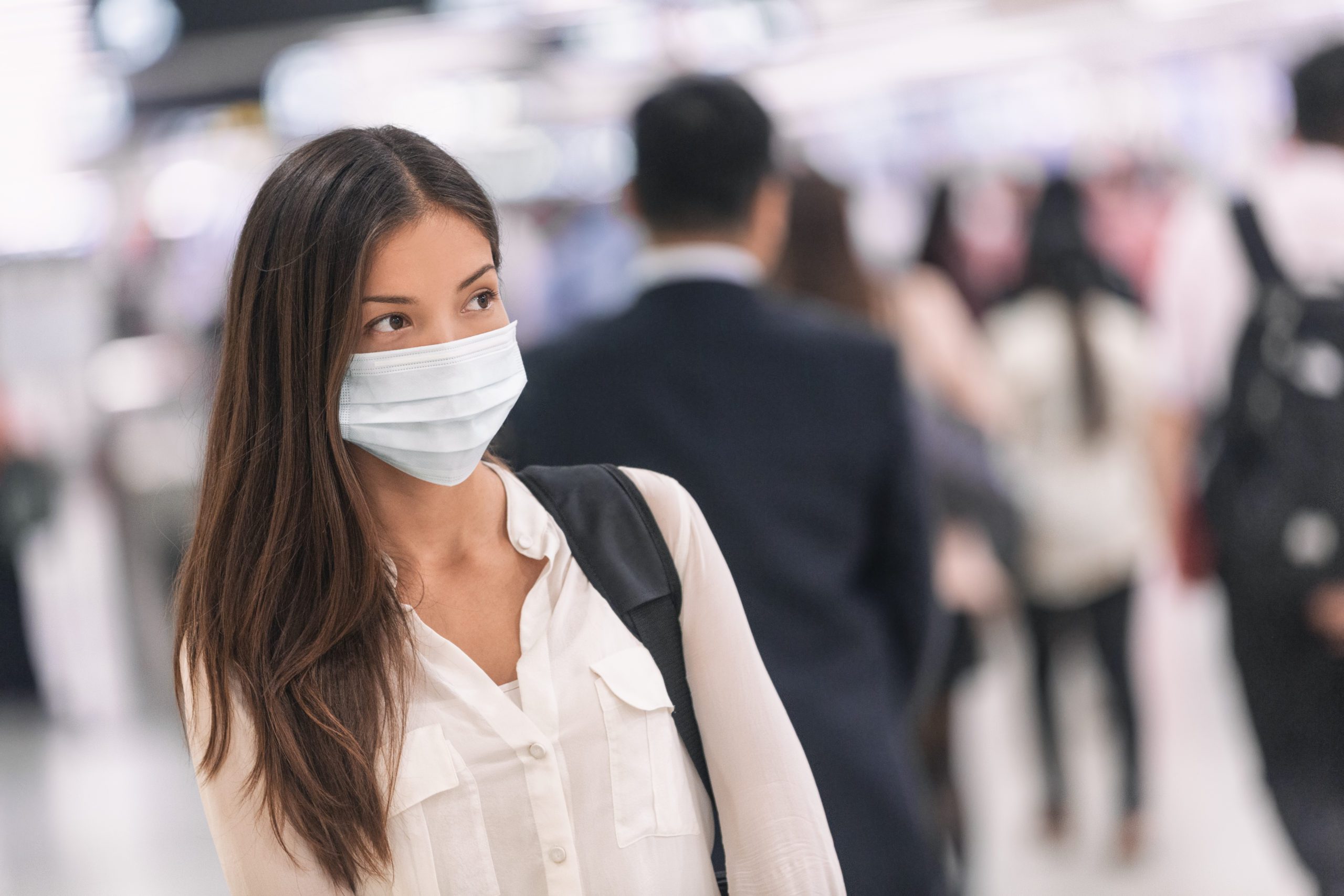 Virus mask Asian woman travel wearing face protection in prevent Virus mask Asian woman travel wearing face protection in prevention for coronavirus in China. Lady walking in public space bus station or airport.